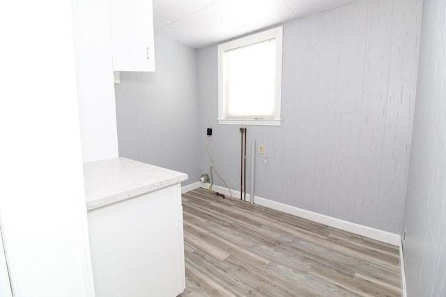 laundry area with light hardwood / wood-style floors