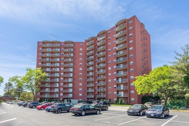 view of building exterior with uncovered parking