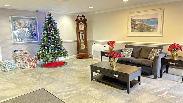 living area with ornamental molding and recessed lighting