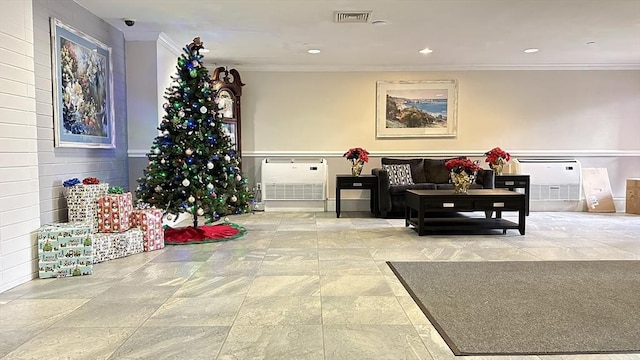 lobby featuring heating unit and visible vents