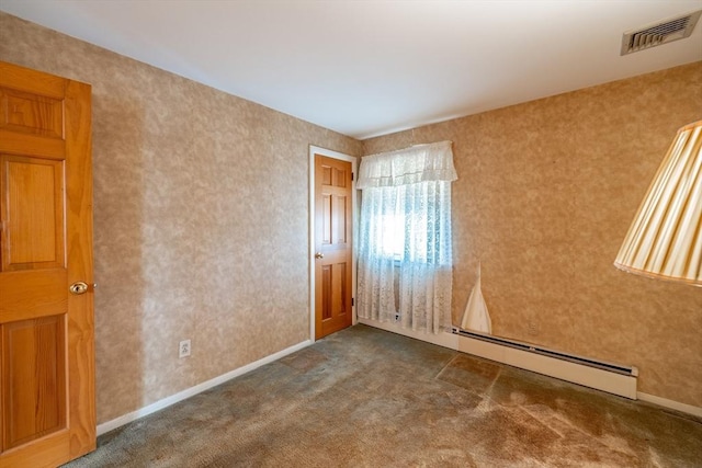 carpeted empty room with baseboards, visible vents, and a baseboard radiator
