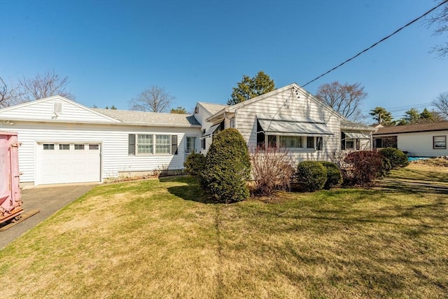 view of front of property featuring a front yard, driveway, and a garage