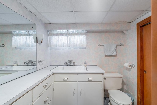 bathroom featuring toilet, wallpapered walls, vanity, and plenty of natural light
