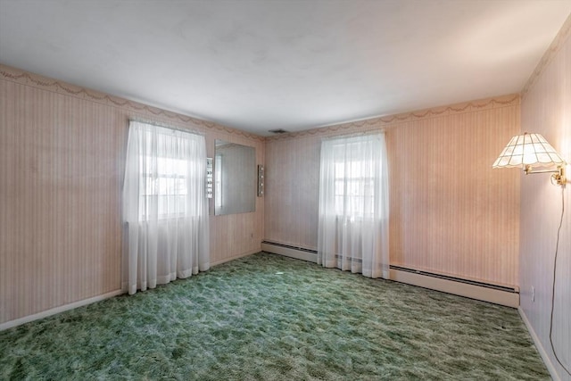 unfurnished room featuring a wealth of natural light, a baseboard radiator, and carpet