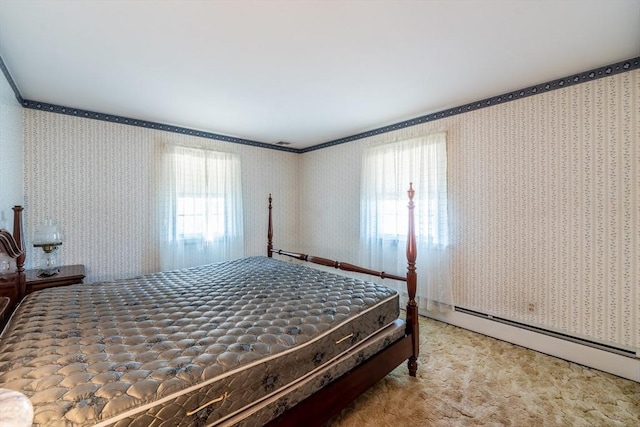bedroom with wallpapered walls, multiple windows, and baseboard heating