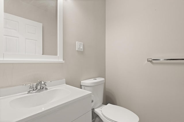 bathroom with toilet and vanity