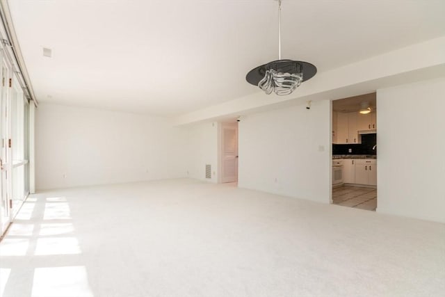241 Perkins St Unit J602, Boston, MA 02130 - unfurnished living room featuring light carpet and a ceiling fan
