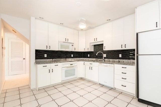 241 Perkins St Unit J602, Boston, MA 02130 - kitchen featuring white appliances, light flooring, backsplash, and white cabinetry