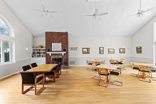 225 Lincoln St Unit G3, Duxbury, MA 02332 - dining room with high vaulted ceiling, light wood-style floors, a fireplace, and a ceiling fan