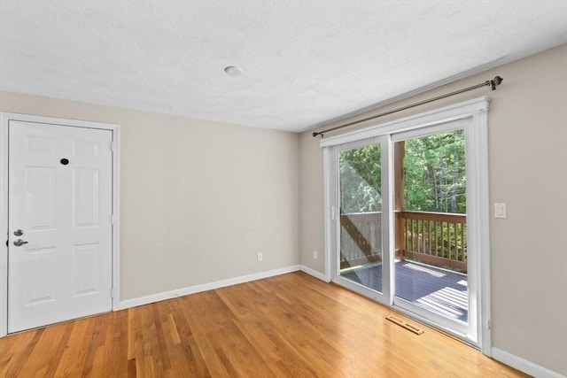 225 Lincoln St Unit G3, Duxbury, MA 02332 - empty room with wood finished floors and a textured ceiling