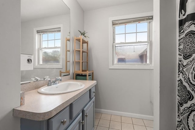 bathroom with a shower with shower curtain, vanity, washer / dryer, and tile patterned flooring