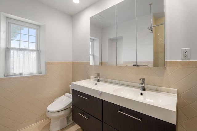 full bath with toilet, a sink, tile walls, double vanity, and walk in shower