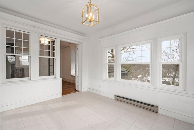 interior space featuring a notable chandelier, baseboards, baseboard heating, and a wealth of natural light