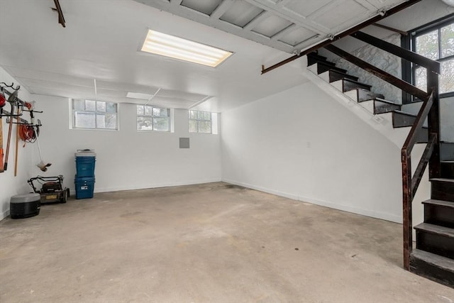 basement with stairway and baseboards