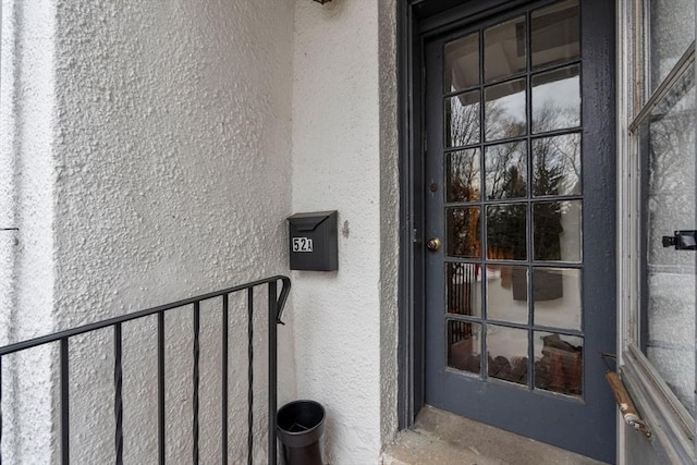 property entrance with stucco siding