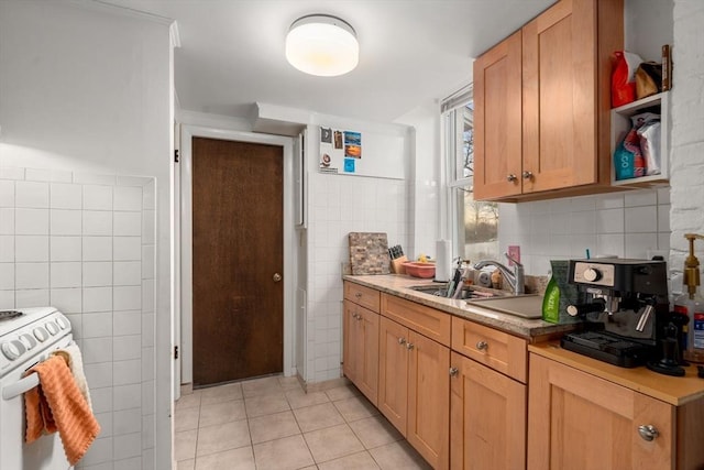 kitchen with a sink, light countertops, white range, tile walls, and light tile patterned flooring