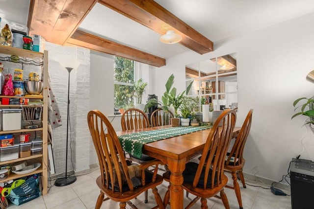 dining area featuring light tile patterned floors and beam ceiling