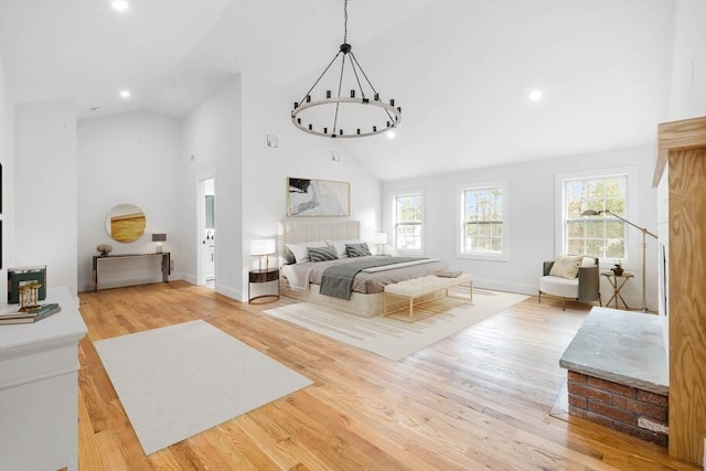 bedroom featuring high vaulted ceiling and light hardwood / wood-style floors