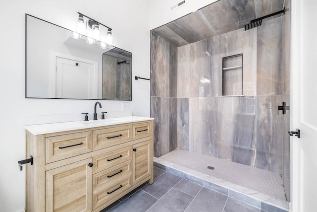 bathroom featuring walk in shower, vanity, and tile patterned floors