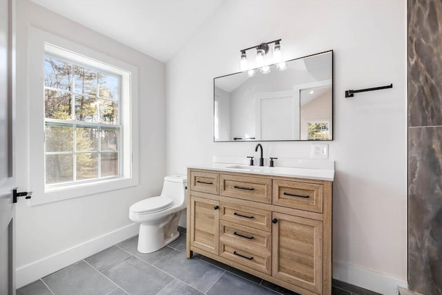 bathroom with vaulted ceiling, toilet, and vanity