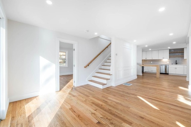 unfurnished living room featuring light hardwood / wood-style floors