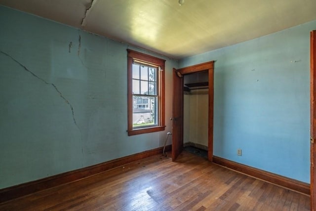 unfurnished bedroom with hardwood / wood-style floors