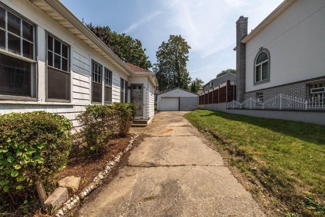 view of home's exterior with an outdoor structure, a yard, and a garage