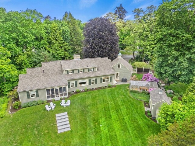 114 Chestnut St, North Reading, MA 01864 - back of property featuring a yard, a sunroom, and a chimney