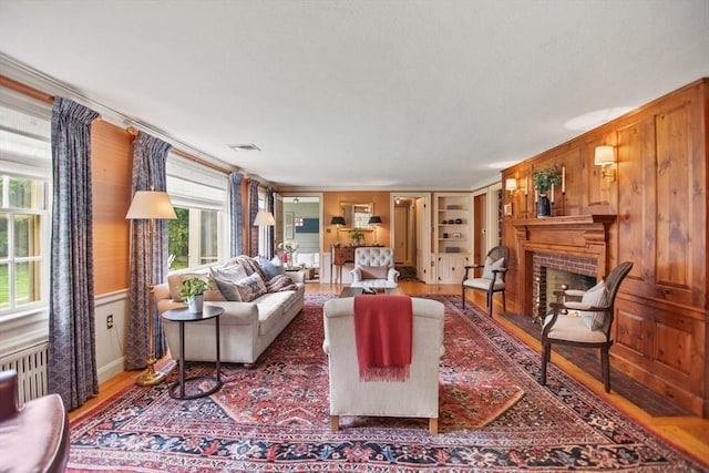114 Chestnut St, North Reading, MA 01864 - living room featuring wood finished floors, a fireplace, and crown molding