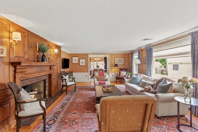 114 Chestnut St, North Reading, MA 01864 - living area with a fireplace, wood finished floors, and ornamental molding