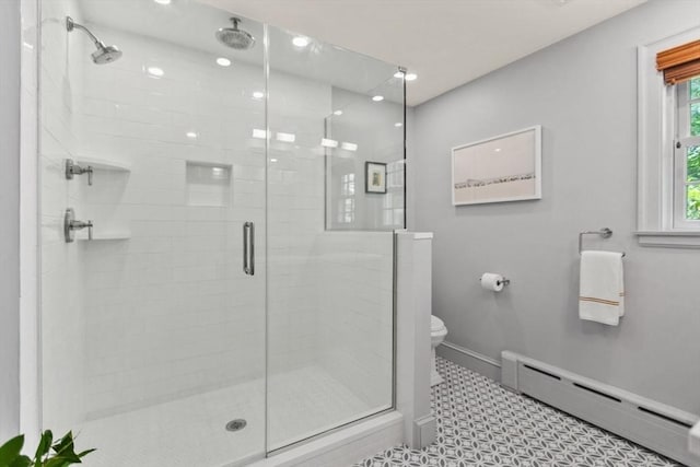 114 Chestnut St, North Reading, MA 01864 - bathroom featuring a baseboard heating unit, baseboards, a shower stall, and toilet