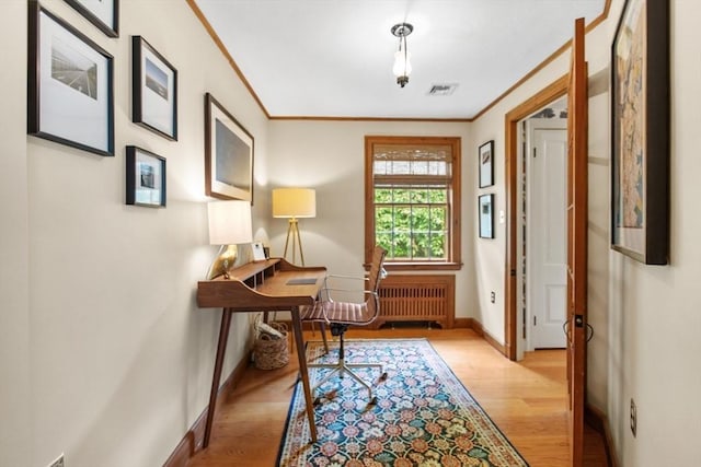 114 Chestnut St, North Reading, MA 01864 - entryway with radiator heating unit, baseboards, light wood finished floors, and crown molding