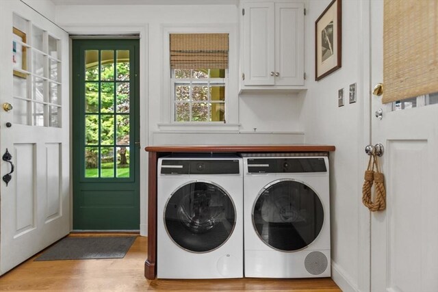 114 Chestnut St, North Reading, MA 01864 - laundry area with cabinet space, washing machine and clothes dryer, and light wood-type flooring