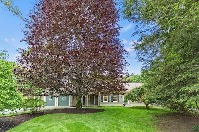 114 Chestnut St, North Reading, MA 01864 - obstructed view of property with a front lawn, a garage, and driveway