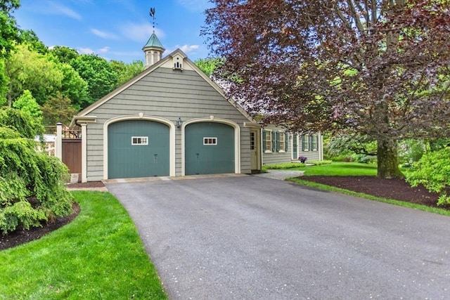 114 Chestnut St, North Reading, MA 01864 - view of front of house featuring asphalt driveway, an attached garage, and a front lawn