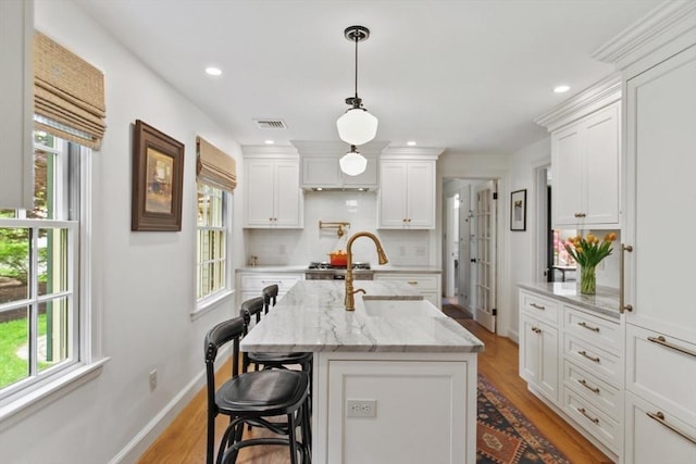 114 Chestnut St, North Reading, MA 01864 - kitchen featuring plenty of natural light, light wood-style floors, white cabinets, and recessed lighting