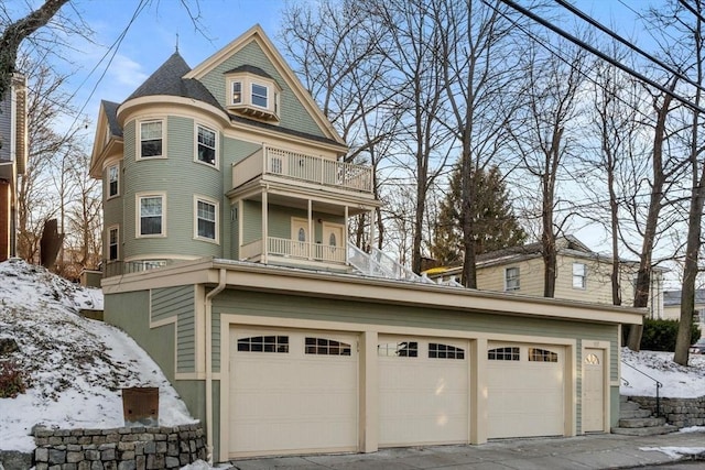 view of front facade with a garage and a balcony