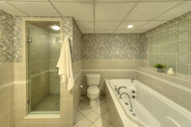 bathroom featuring tile walls, separate shower and tub, a drop ceiling, tile patterned floors, and toilet