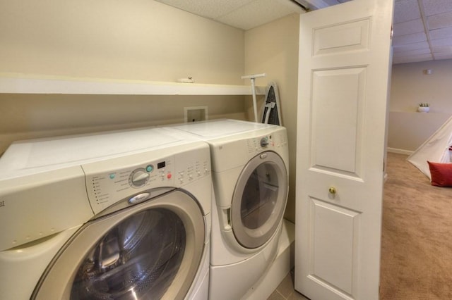 laundry room with separate washer and dryer and light colored carpet