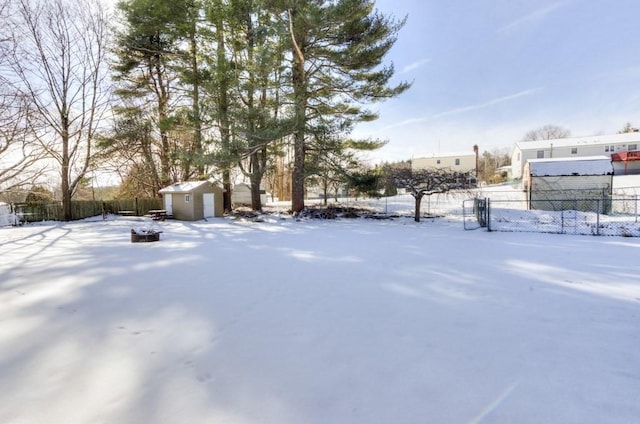 yard covered in snow featuring a storage unit