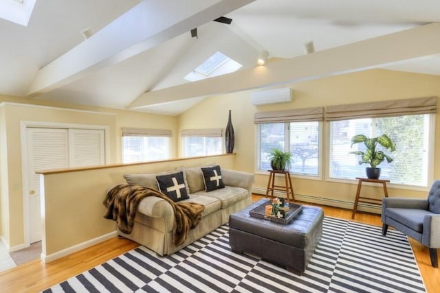 living room with a baseboard heating unit, light hardwood / wood-style flooring, lofted ceiling with skylight, and an AC wall unit