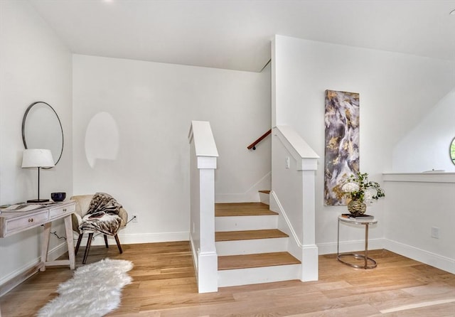 stairs with hardwood / wood-style floors