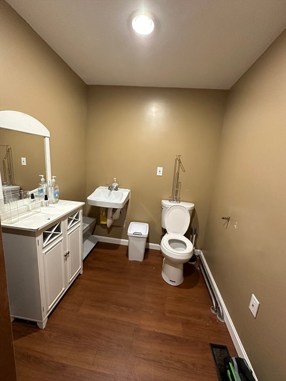 bathroom with vanity, hardwood / wood-style floors, and toilet