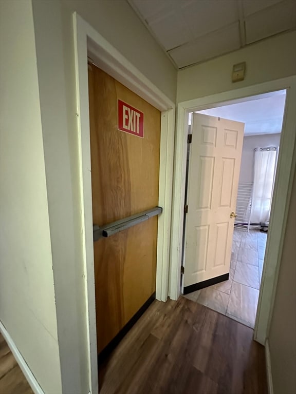 hallway with hardwood / wood-style floors