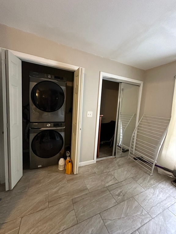 laundry room featuring stacked washer / dryer