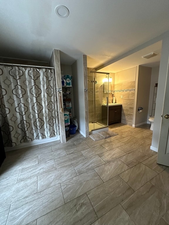 bathroom featuring vanity, a shower with shower curtain, and toilet