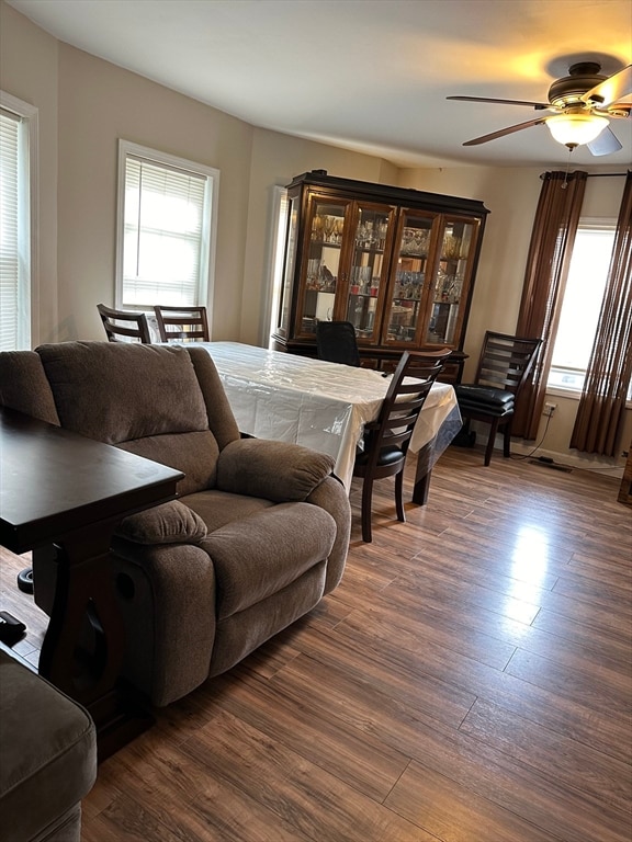 living room featuring dark hardwood / wood-style floors and ceiling fan