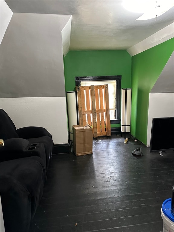 living room with lofted ceiling and dark hardwood / wood-style floors