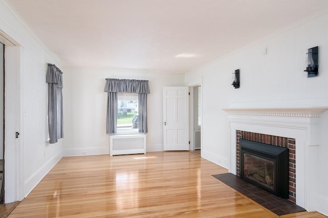 20 Blaine Ave, Worcester, MA 01603 - unfurnished living room featuring radiator, light wood-style floors, a fireplace, and ornamental molding