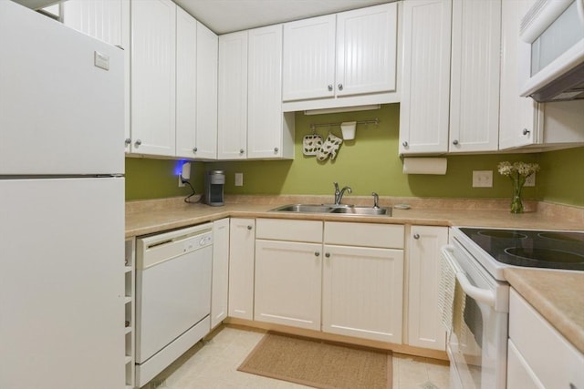 145 Milk St Unit 10, Westborough, MA 01581 - kitchen featuring white appliances, ventilation hood, light countertops, and white cabinetry
